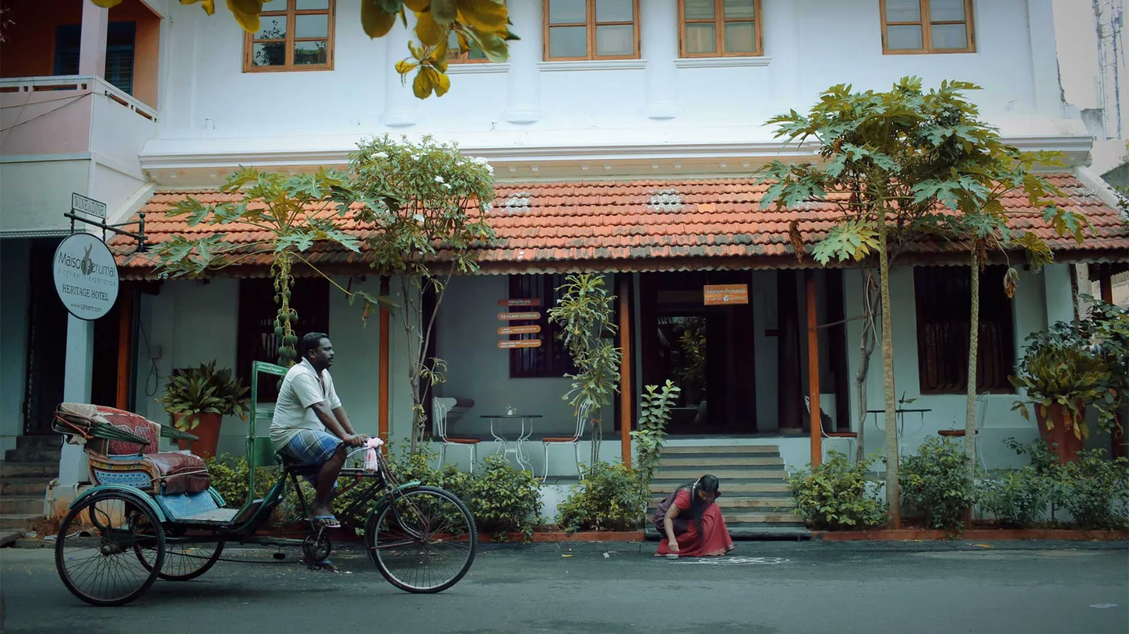 A heritage house with a tiled roof on a street in Pondicherry