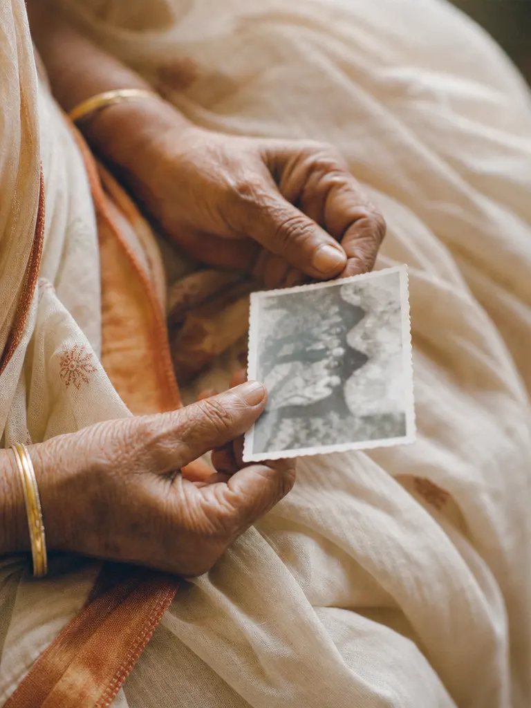 Hands holding an old photograph
